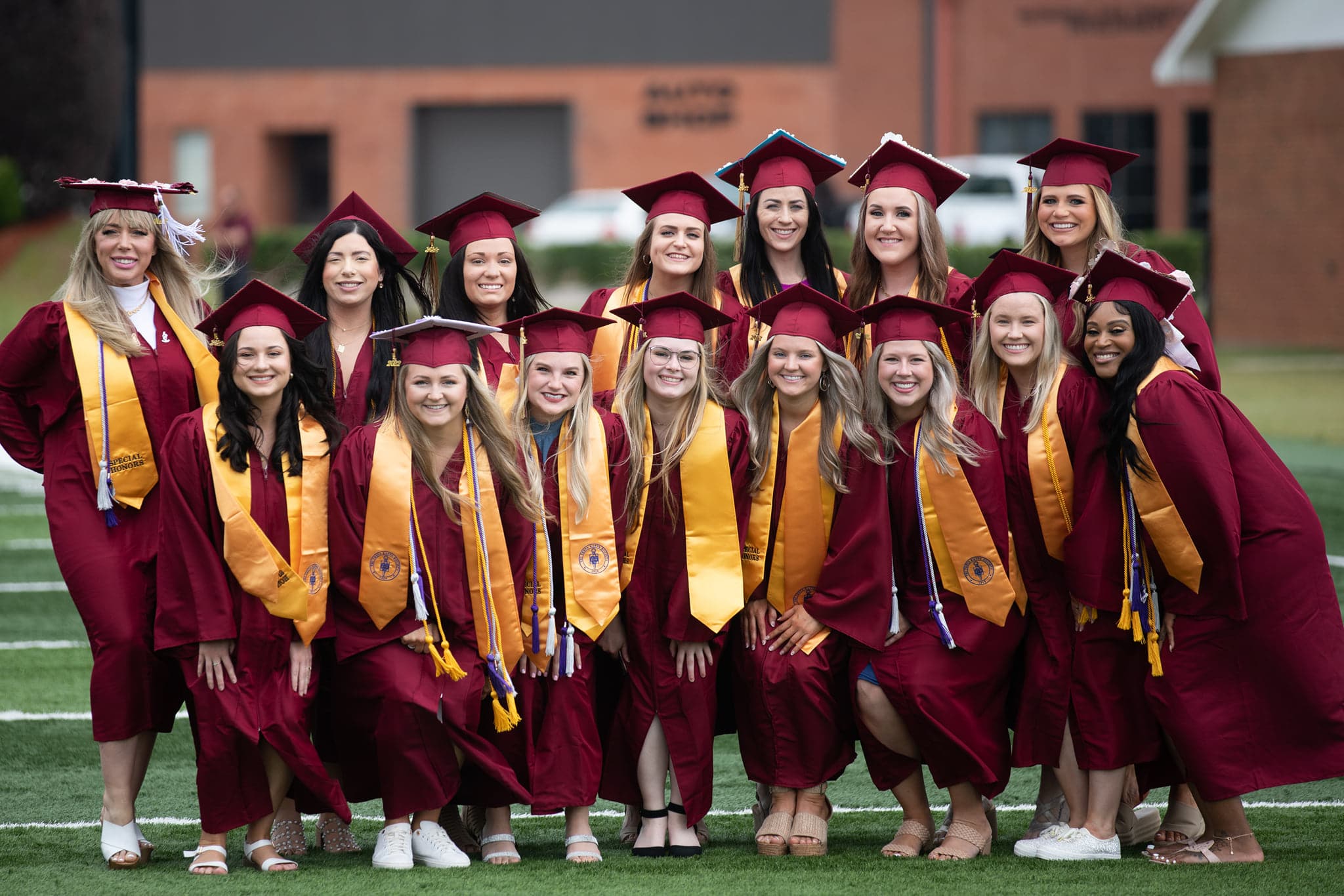 Several women gather in their maroon robes at PRCC Graduation 2022