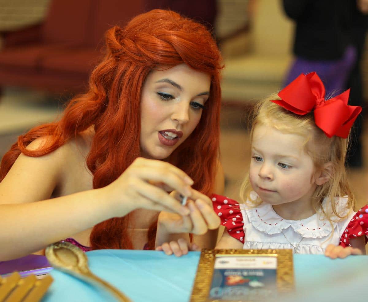 Ariel helps Luna McElroy with her craft at PRCC April 2022