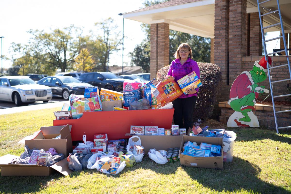 Carol Williams stands by sleigh full of food donations