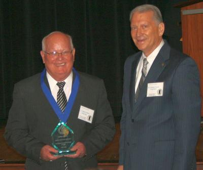PRCC President William Lewis (right) presents J. Larry Ladner with his Mississippi Community  and Junior College Sports Hall of Fame award.