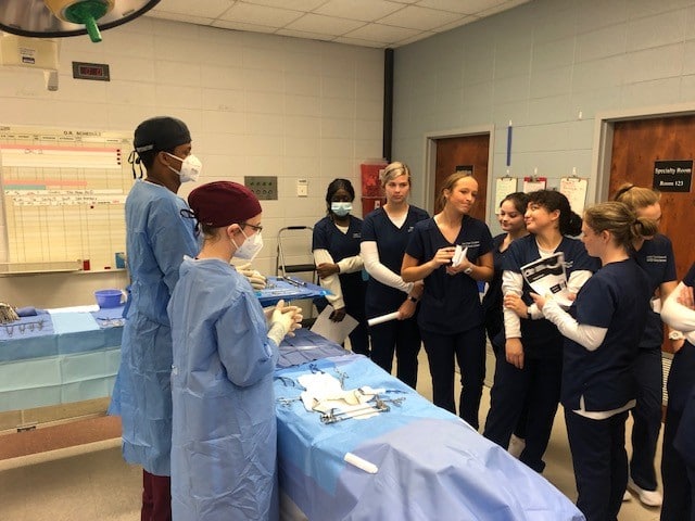 High School students watch demonstration of surgical tech skills by PRCC students