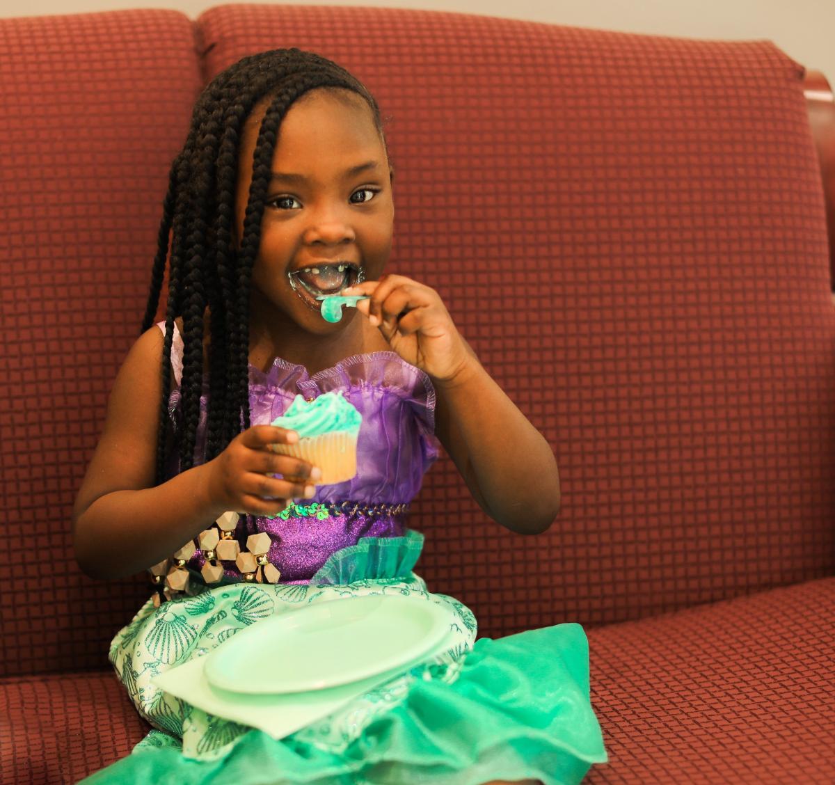 Kensley Myers of Bassfield enjoys her cupcake at the meet and greet April 2022