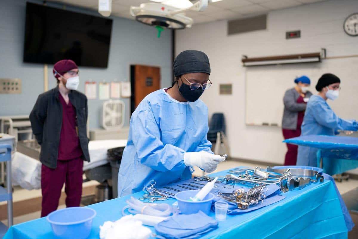 PRCC Surgical Tech student practicing surgicalinstrument set up