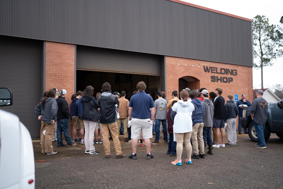Students stand outside welding building to learn about the program at Poplarville CTE Day 2022
