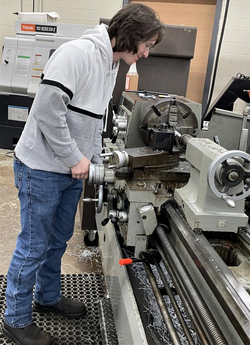 Precision Manufacturing Scholarship Recipient Mitchell Greer using machine