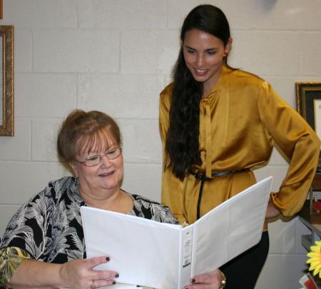 Rachael Carraro (standing) looks over her class work with advisor Dr. Terri Ruckel