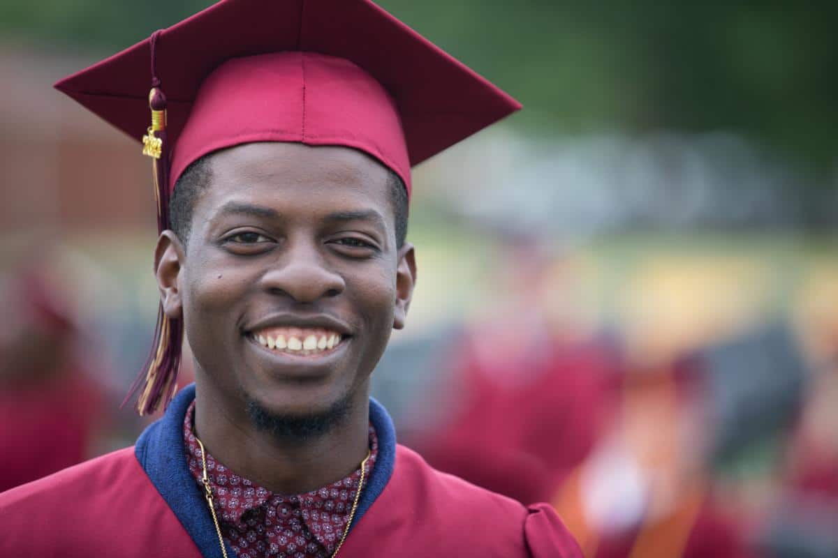 Young man with maroon cap and gown at PRCC Graduation 2022