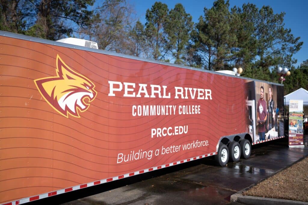 Long trailer with wildcat head on left and image of workforce training on the right. Text reads: Pearl River Community College prcc.edu; building a better workforce.