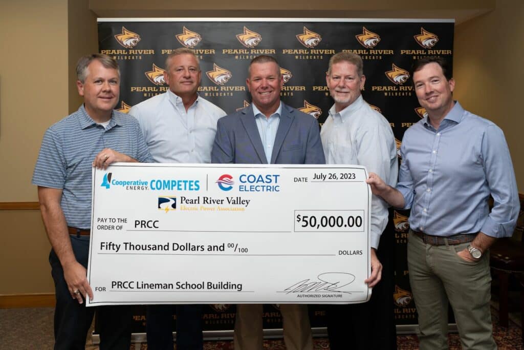 Cooperative Energy, Coast Electric, and Pearl River Valley Electric representatives stand with Dr. Adam Breerwood with a $50,000 check for the PRCC Lineman Program.